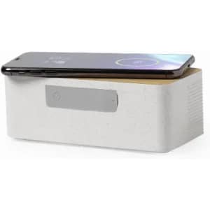 A rectangular wireless charging station in white with a wooden top, featuring a smartphone placed on it.