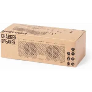 A speaker charger in a cardboard box featuring a simple design and two speaker grilles on the front.