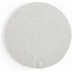A round, grey coaster with a speckled texture and a small indentation. It has a minimalist design.