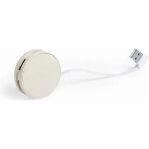 A round white charging cable with a USB connector extending from it. The design is simple and minimalist.
