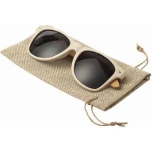 A pair of dark sunglasses resting on a beige fabric pouch with drawstrings.