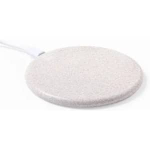 A round, white charging pad with a textured surface and a connected cord.