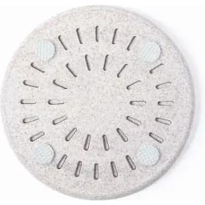 A light grey round product with a textured surface and small holes throughout, featuring four circular elements.