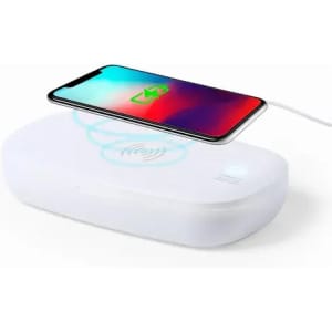 A wireless charging station in white, with a smartphone placed on top, featuring a glowing charging icon.