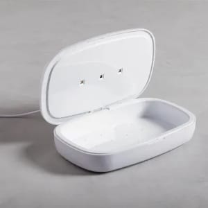 A white, rectangular sanitising case with an open lid, featuring three small indicators inside.