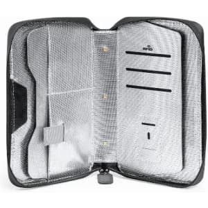 A zippered black case with a silver interior, featuring compartments for cards and a slot for a power bank.
