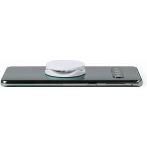A smartphone with a white circular accessory attached to its back. The device features a sleek, dark design.
