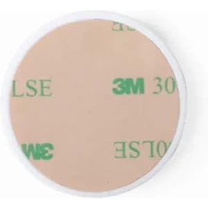 A round adhesive patch with a light beige surface and a white border, featuring discreet branding.