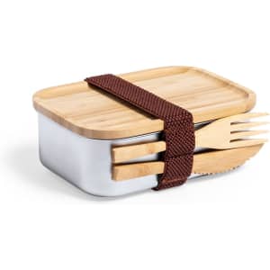 A lunchbox featuring a stainless steel base, bamboo lid, and a brown strap with utensils attached.