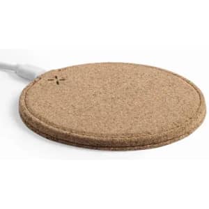 A round cork charging pad with a white charging cable connected, featuring a simple, minimalist design.