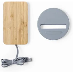 A bamboo charging pad with a grey circular base and USB cable. Includes a slit for easy device placement.
