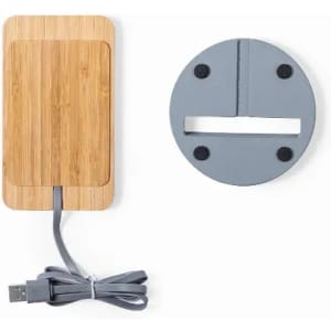 A wireless charger in bamboo and grey, featuring a USB cable and a circular base with rubber foot grips.