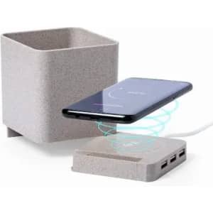 A grey charging station with a wireless charger and multiple USB ports, featuring a minimalist design.