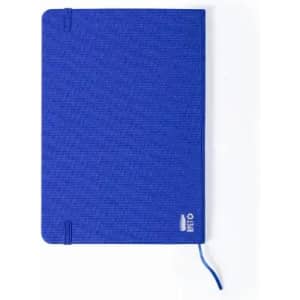 A blue notebook with a textured cover, featuring a logo in the bottom corner and a ribbon bookmark.