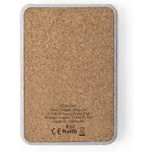 A charging pad with a cork surface and a metallic edge, featuring two USB ports and a wireless charging capability.