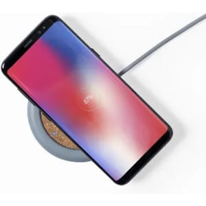 A smartphone on a round wireless charger with a grey colour scheme, displaying a battery percentage of 97%.