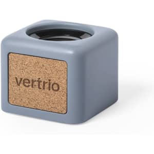 A grey cube-shaped container with a cork front and a logo.