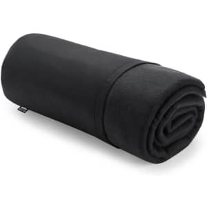 A rolled black fleece blanket, neatly folded, featuring a branding label on the edge.