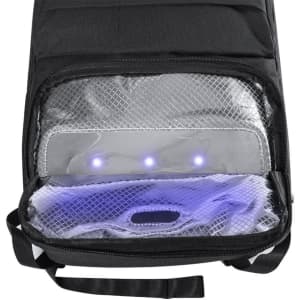 A black backpack interior featuring a mesh compartment with LED lights illuminating the contents.