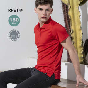 A red polo shirt is worn by a young man sitting against a textured background with cacti. The shirt features a logo.