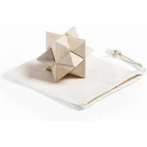 A wooden puzzle toy in natural shades, resting on a white fabric pouch with a drawstring.