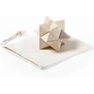 A wooden puzzle featuring geometric shapes, placed on a white drawstring pouch. The colours are natural wood tones.