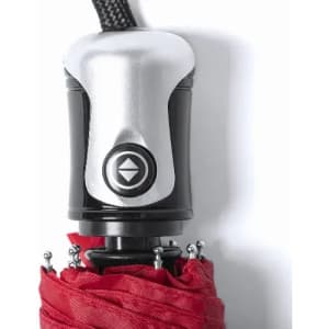 A red umbrella with a silver handle, featuring a button mechanism at the top. It has a sleek, modern design.
