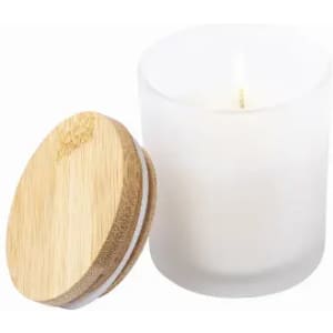 A candle in a frosted glass jar with a bamboo lid. The wax is white, and the wick is visible.