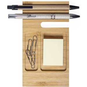 A bamboo organiser featuring two pens, paper clips, and a sticky note pad in a minimalist design.