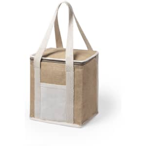 A square jute cooler bag in brown with white straps and a front pocket. It features a zip closure.