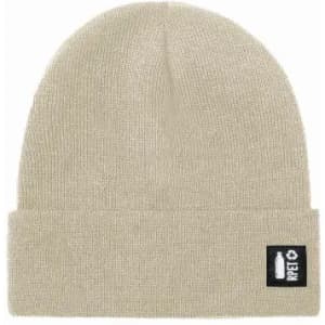 A beige beanie hat with a folded cuff and a logo patch on the side.