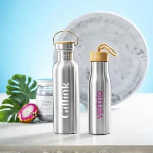 A drink bottle with a stainless steel body and bamboo cap, featuring a logo. Another similar bottle is adjacent.