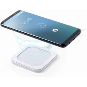 A wireless charging pad in white with a smartphone hovering above it, displaying a charging icon on the screen.