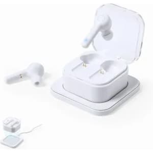 A pair of white wireless earbuds placed next to their charging case, with a charging cable visible.