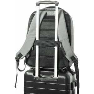 A grey backpack secured on top of a black suitcase, featuring adjustable straps and a telescopic handle.