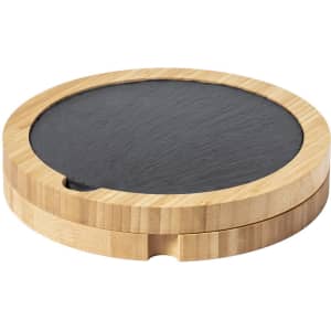 A round bamboo coaster with a black slate top, featuring a small indentation on the edge.