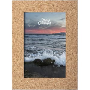 A cork-framed picture displaying a scenic view of ocean waves at sunset. The frame features a natural brown colour.