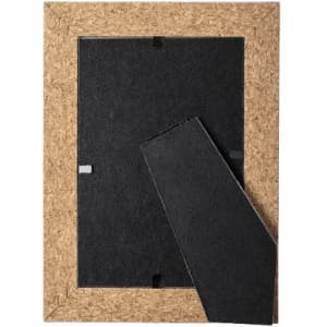 A cork photo frame with a removable backing, featuring a black interior and a natural cork border.
