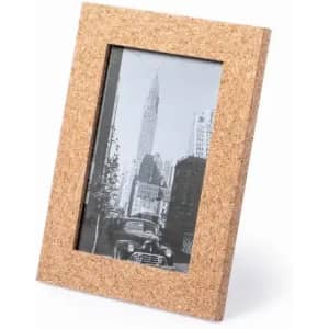 A cork photo frame displaying a black and white image of a city skyline. The frame has a natural textured finish.