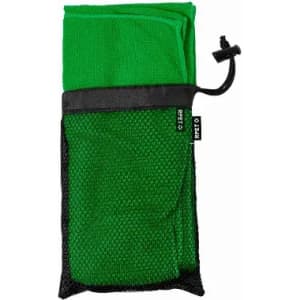 A green towel packaged in a black mesh carry bag, secured with a drawstring. The bag features a logo.