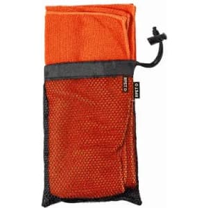 A compact orange towel rolled and secured in a black mesh pouch with a drawstring. It has a logo on the pouch.