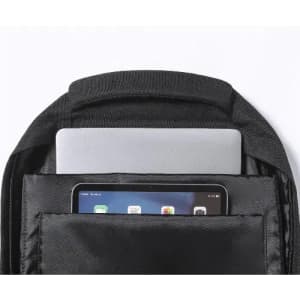 A black backpack with a laptop and tablet stored in separate compartments. The interior is sleek and minimally designed.