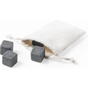 A fabric pouch containing four grey whiskey stones, designed for chilling beverages.