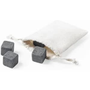A drawstring bag contains several grey whisky stones. The bag is light-coloured, with stones visible outside.