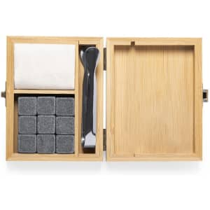 A wooden box containing drink stones, a cloth, and a serving tool. The box is made of bamboo.