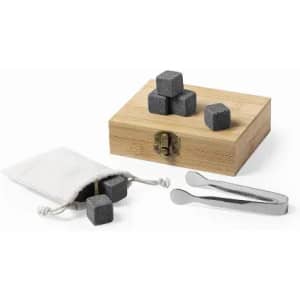 A wooden box containing grey whisky stones, a small pouch, and a pair of tweezers for handling the stones.
