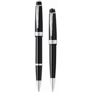 Two elegant black pens with silver accents, featuring a polished finish and a sleek design. Each pen has a logo.