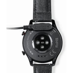 A black smartwatch with a leather strap, featuring sensor lights and a charging port on the back.