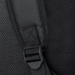 A close-up of a black fabric with a buckle attachment, featuring a textured surface and stitching details.