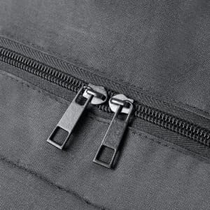 A close-up of a grey fabric with a black double zipper, showcasing the detailed stitching and zip mechanism.